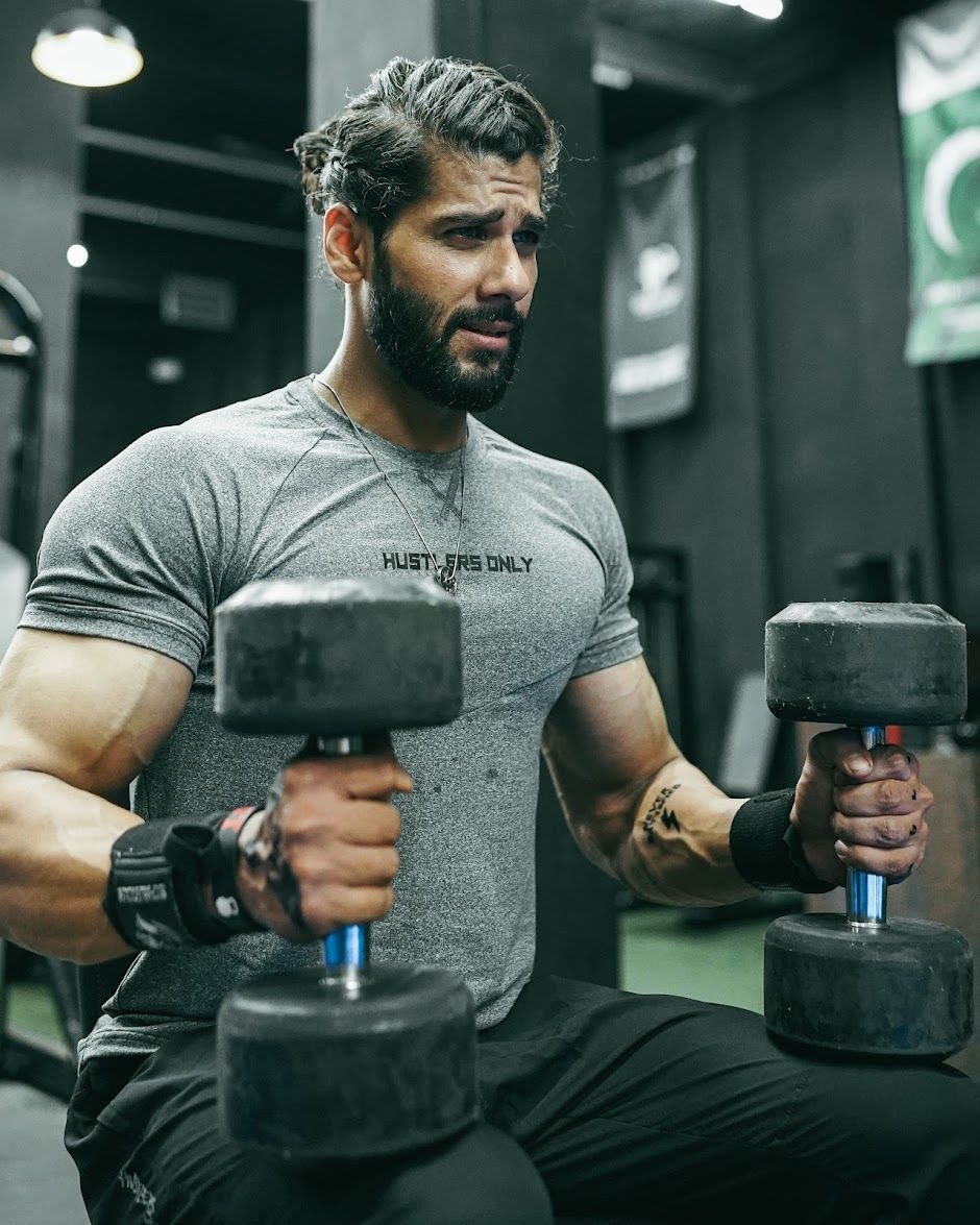 Athlete doing seated dumbbell work