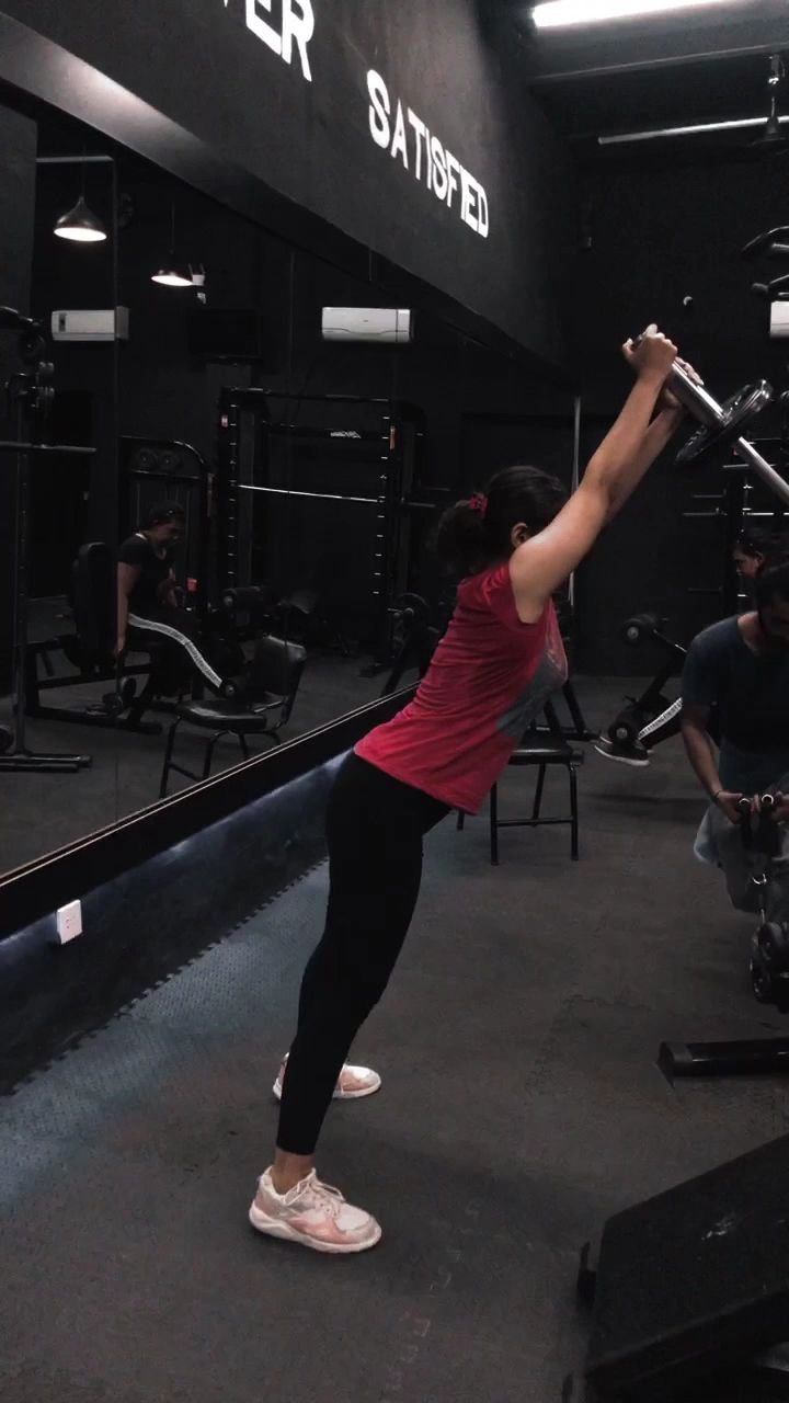 Member doing an overhead barbell stretch